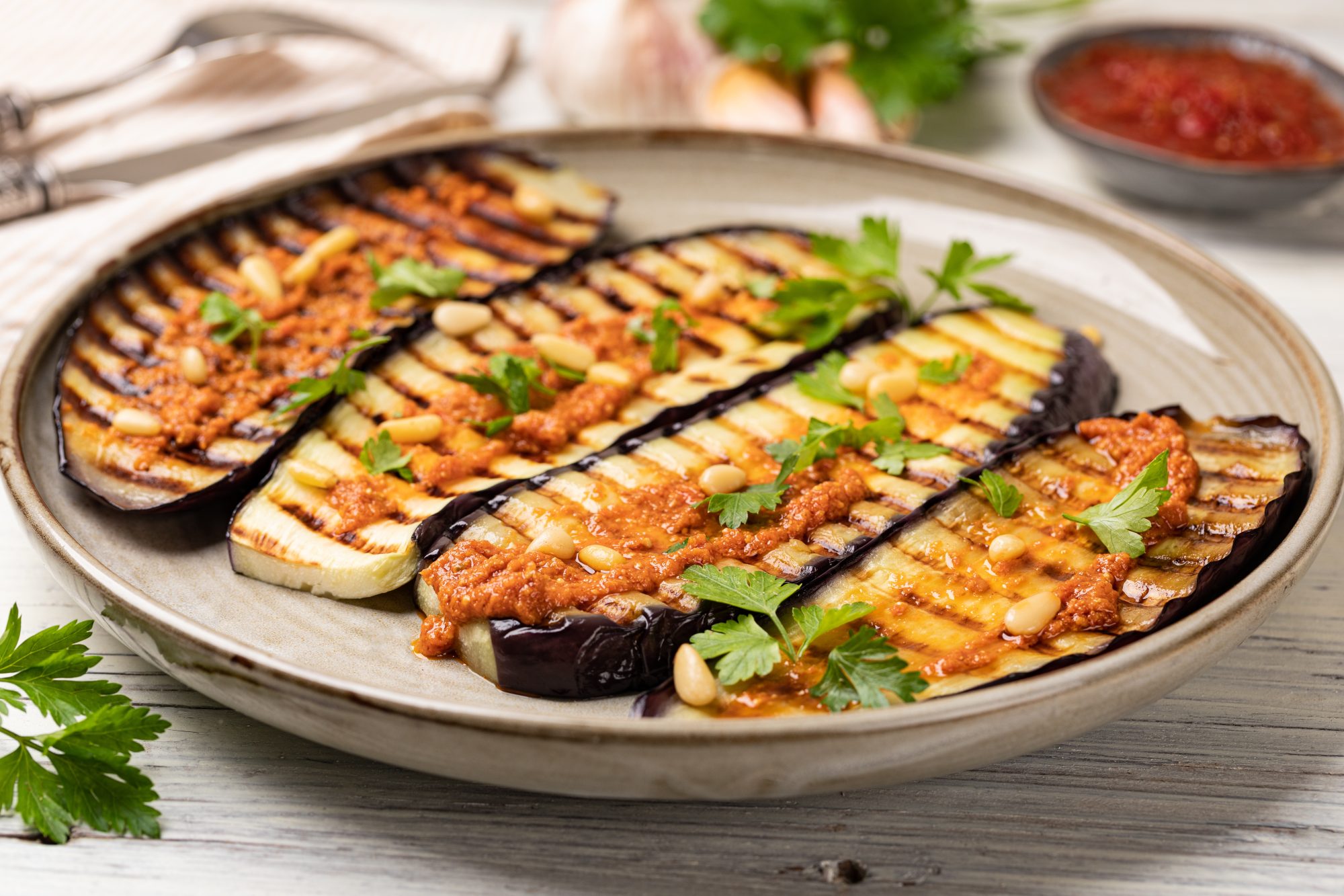 Mediterranean Roasted Eggplant on a plate with sauce and parsley