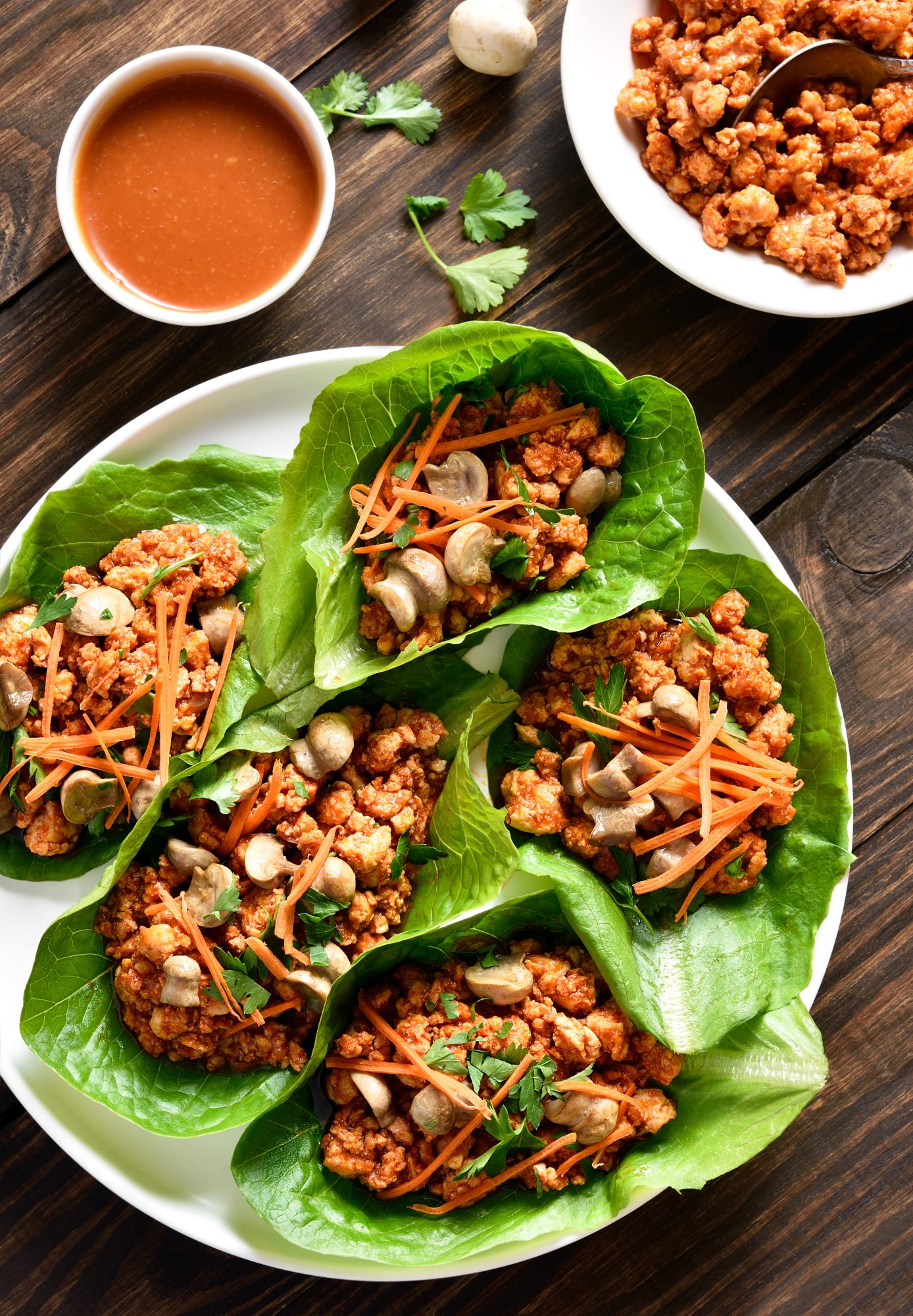 Chicken lettuce wraps on wooden table. Top view, flat lay